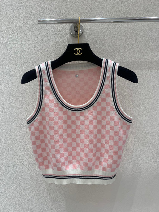 Pink and white checkerboard knit vest with a metal logo clasp on the back